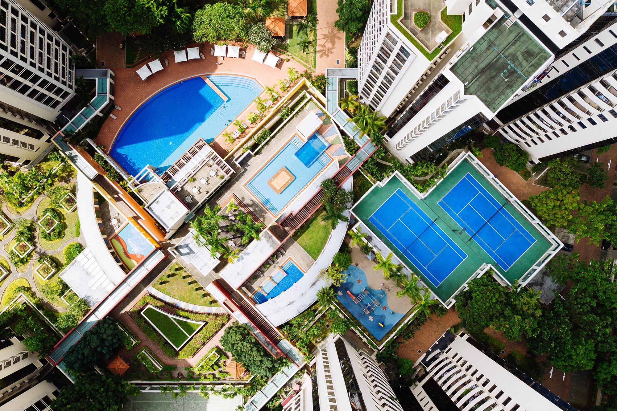 Sky view of pools and tennis courts at a multifamily complex