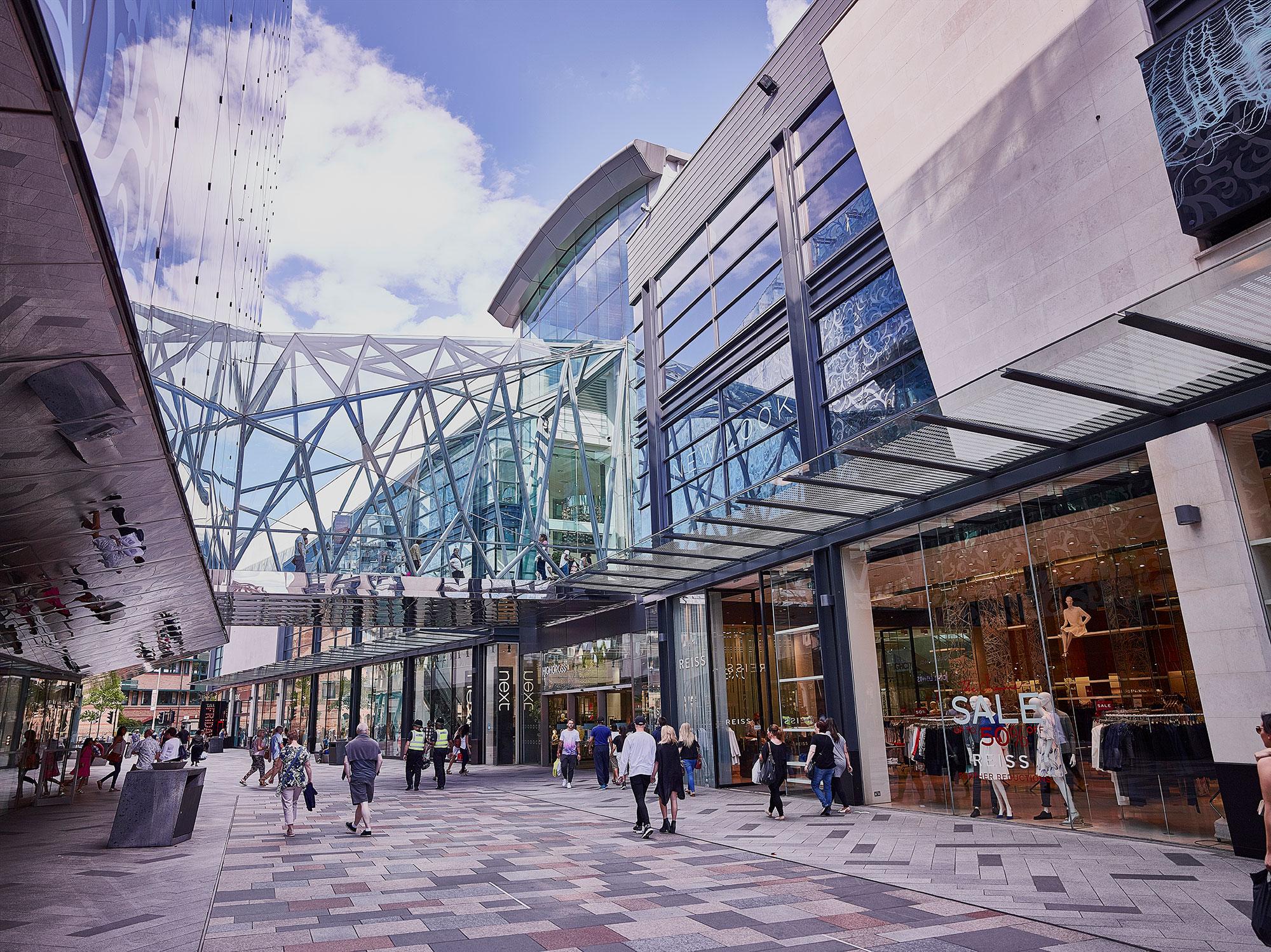 People walking through a mixed-use development complex