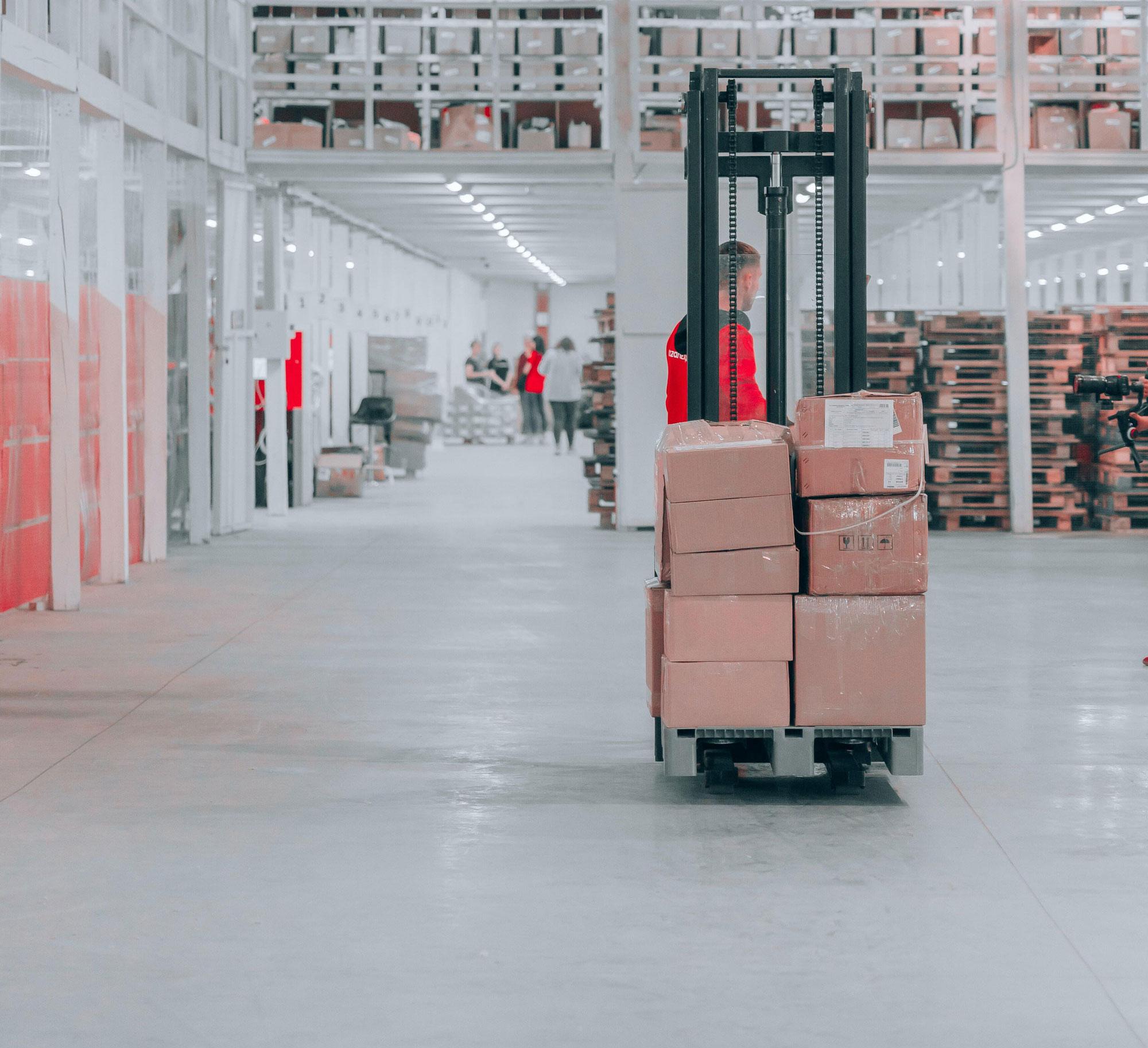 Man operating machinery in a factory warehouse